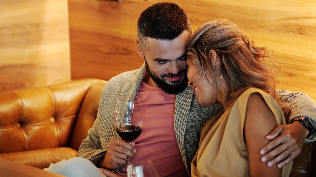 Couple on a couch drinking wine