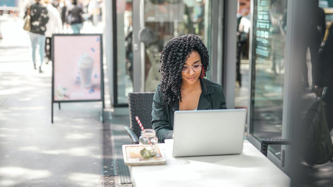 Woman at cafe working on laptop