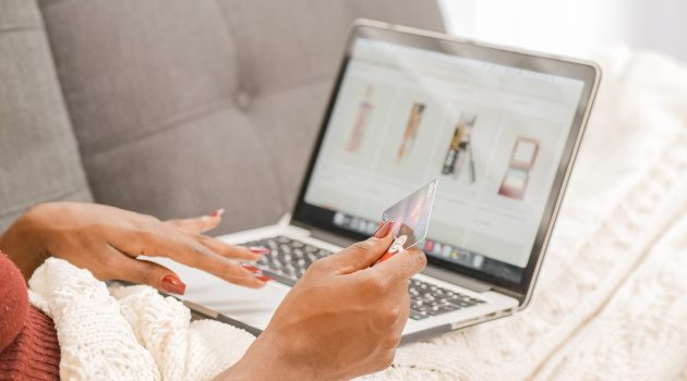 Woman shopping online holding a credit card