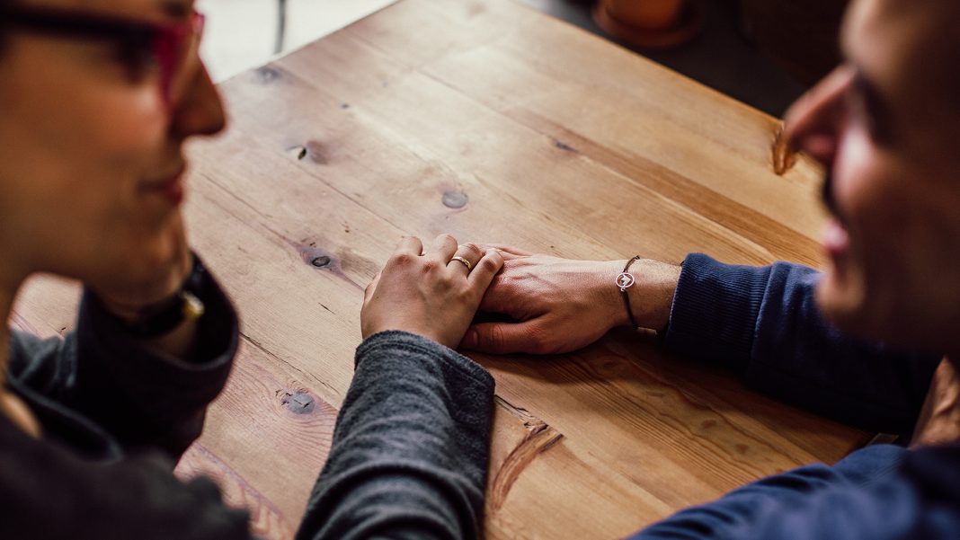 Woman touching a man's hand
